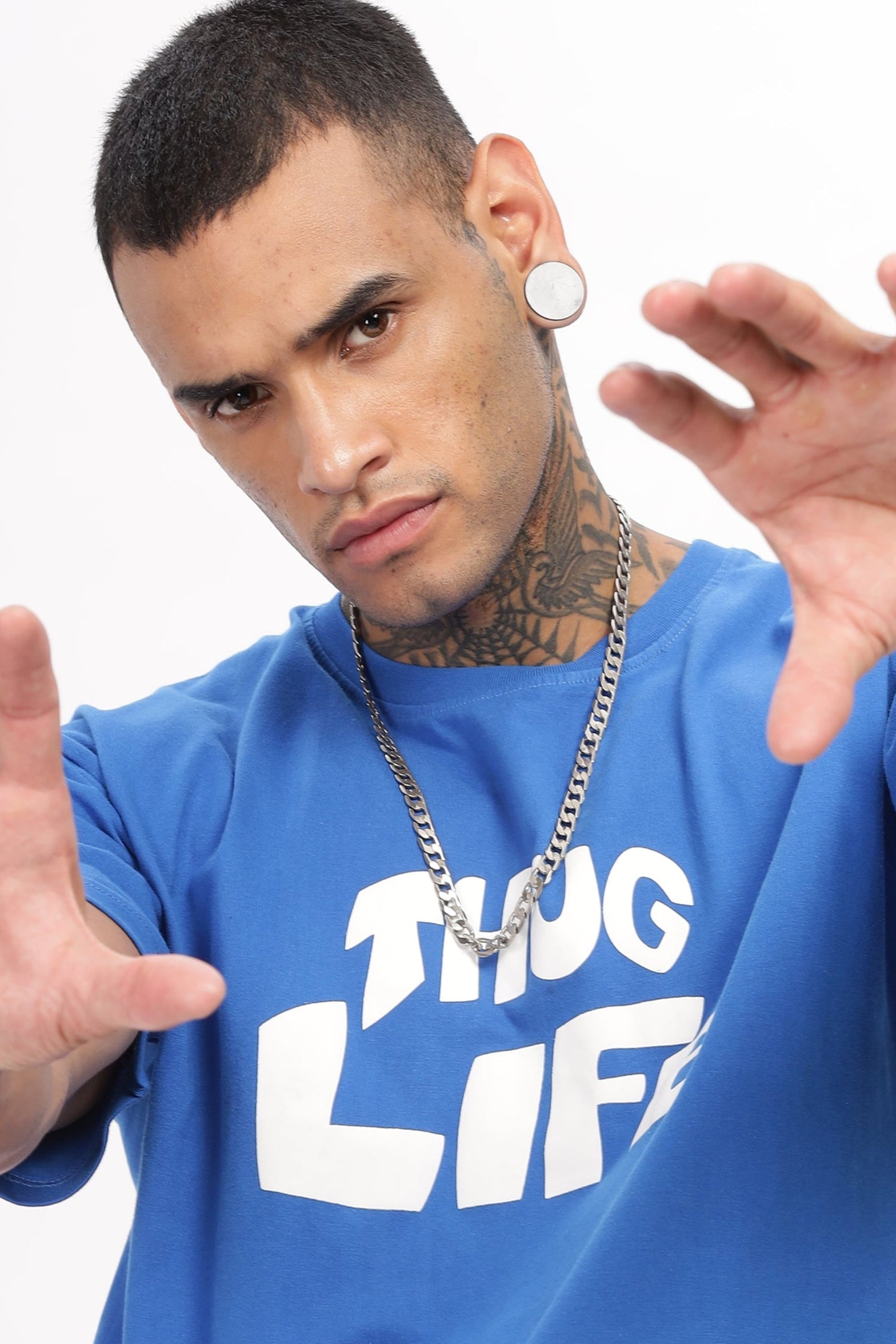 Person wearing a blue 'THUG LIFE' t-shirt on a white background